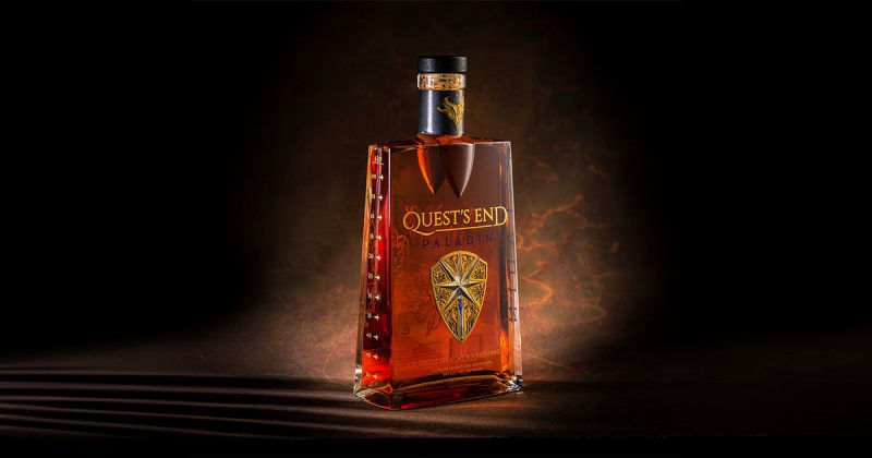 A bottle of Quest's End Whiskey with a flexible aluminium label made by Signet.