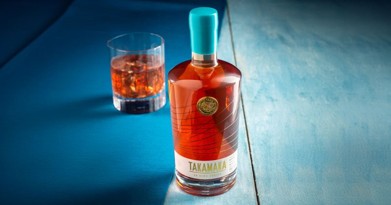 A bottle of Takamaka Rum featuring a gold diecast coin embellishment produced by Signet